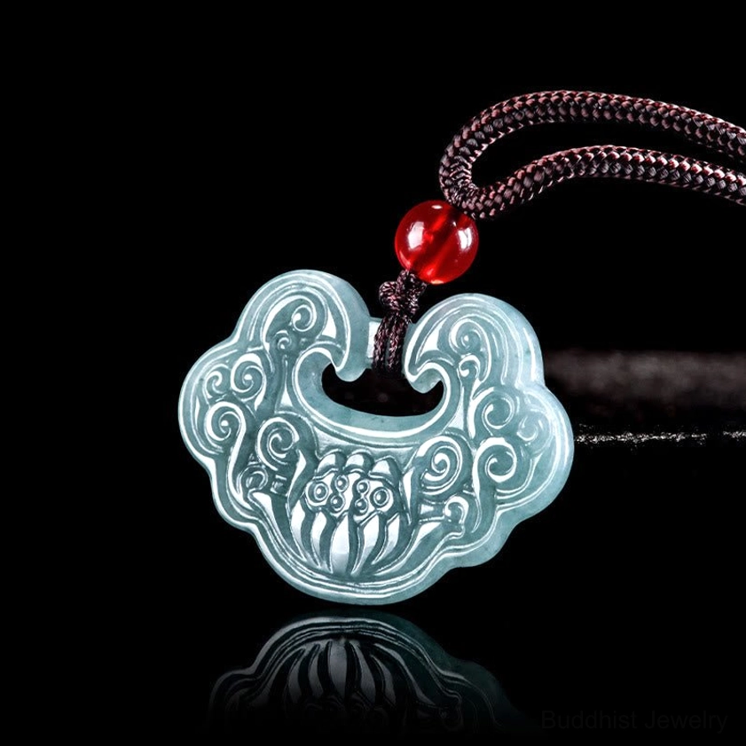 Light blue jade Ruyi lock pendant necklace with brown braided cord and red bead accent - top-down close-up view