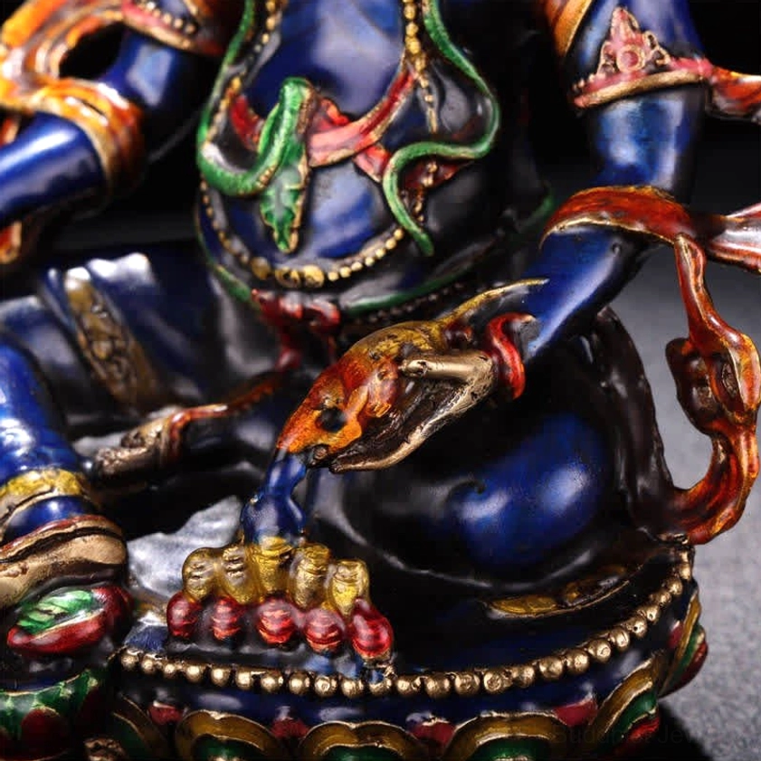 Jambhala Buddha torso and leg area detail showing enamel painted snake motifs stacked red treasure offerings and ornate arm trims