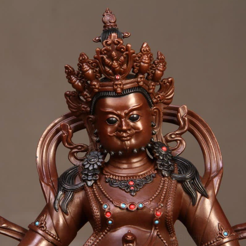 Handcrafted Yellow Jambhala copper Buddha statue showing artisan craftsmanship