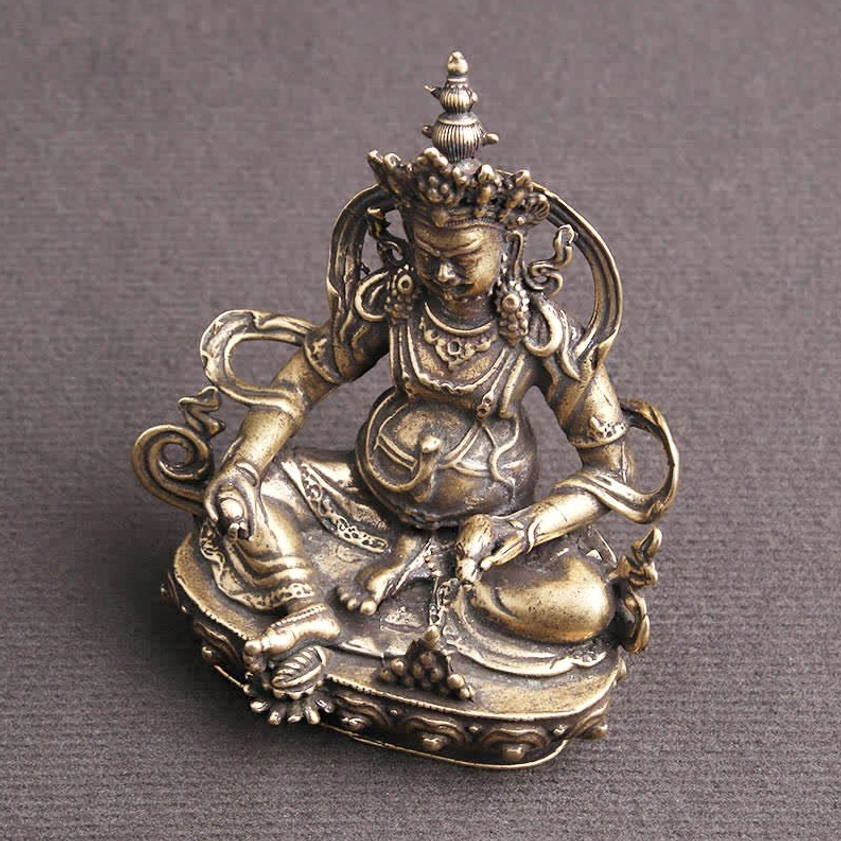 Jambhala Buddha figurine right angle view with detailed jewelry ornaments and aged copper metal finish