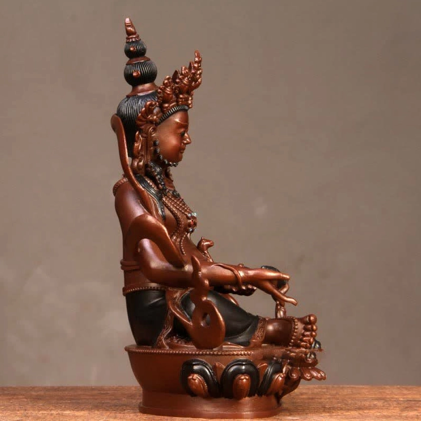 Jambhala Buddha figurine left side profile with seated posture and lotus pedestal