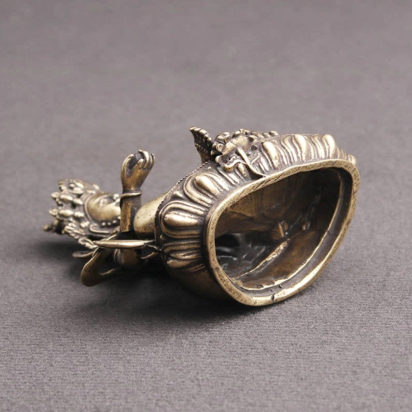 Yellow Jambhala Buddha statue lotus base top-down view showing hollow pedestal and metal craftsmanship