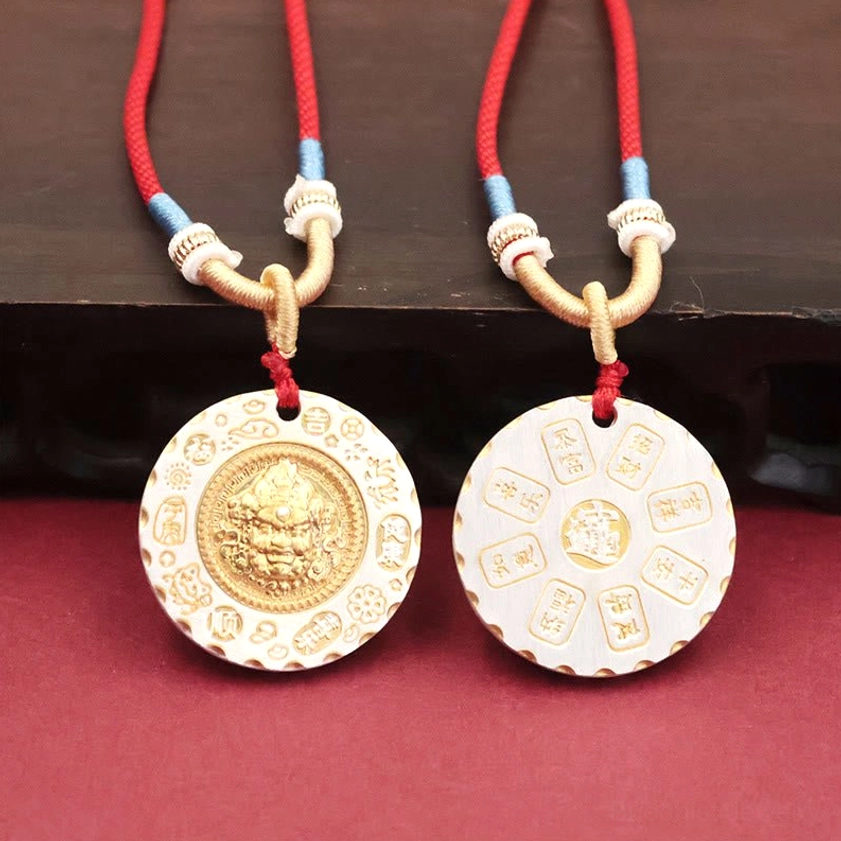 Pair of Yellow Jambhala wealth deity pendants showing front relief carving and reverse side sutra engravings for Buddhist practice