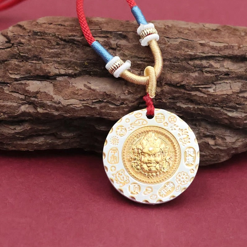 Buddhist Yellow Jambhala protection pendant with dual-tone metal and engraved religious mantras around the edge on red cord