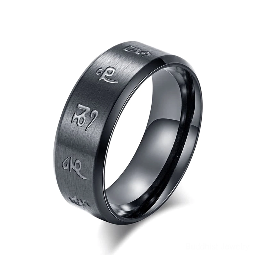 Detailed close-up of hand-engraved Jambhala mantras on black titanium steel ring, showing craftsmanship and sacred script clarity