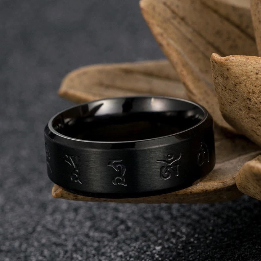Front-facing view of Jambhala mantra ring displaying smooth polished inner band and engraved Buddhist religious symbols