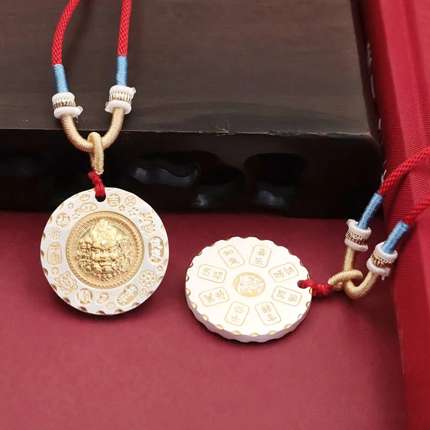 Yellow Jambhala pendant with cord showing dual view - front deity motif and reverse side featuring Buddhist text engravings and protective mantras