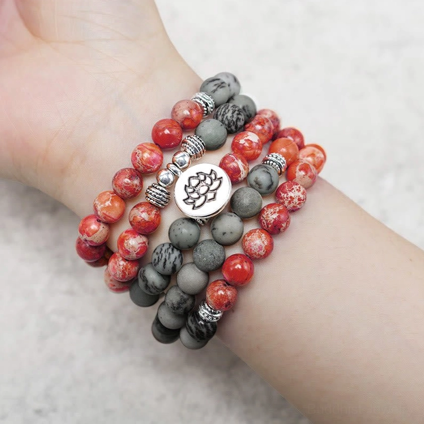 Worn mala bracelet on wrist showing layered wear and natural stone color variation