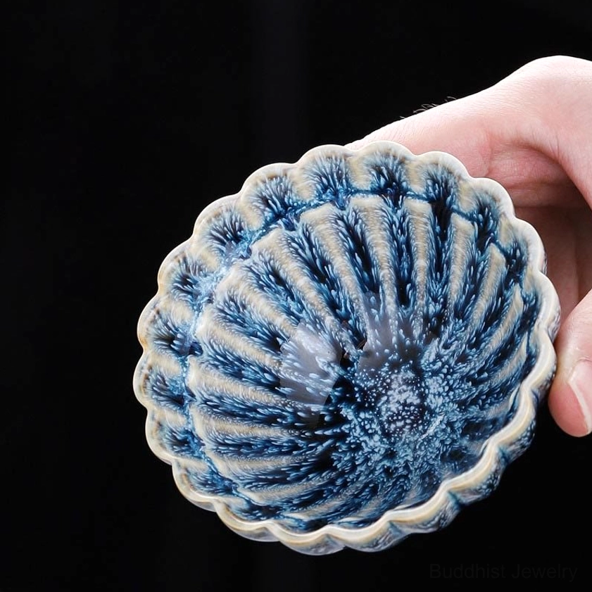 Jian zhan buddhist ceramic lotus teacup in hand showing authentic artisan craftsmanship