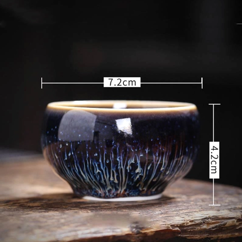 Jian Zhan ceramic tea cup side view with dimensions marked 7.2cm width and 4.2cm height, showing complete cup profile on wooden surface