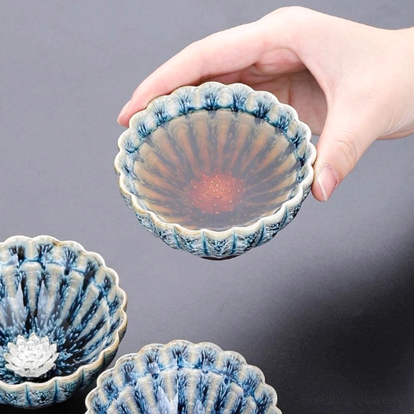 Brewed tea in lotus jian zhan cup showing blue mottled petal glaze and authentic kiln effects