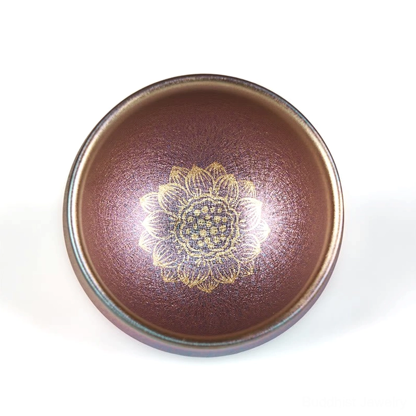 Premium handmade Jianzhan golden lotus teacup with deep reddish-brown glaze and detailed gold floral pattern - flat lay top-down view