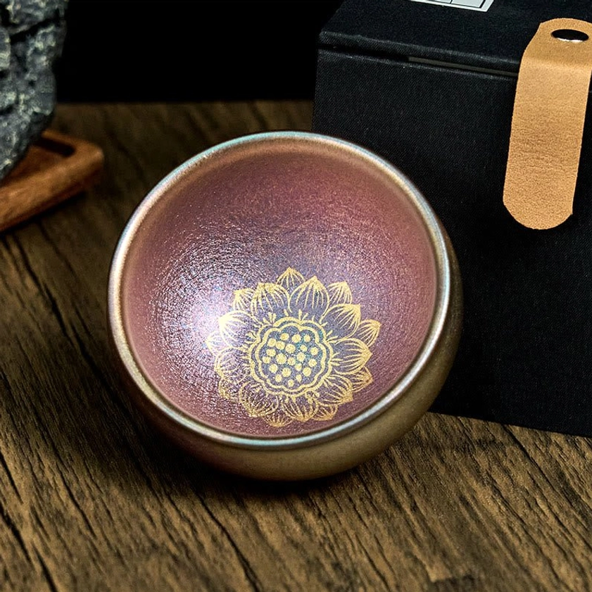 Authentic Jianzhan Buddhist ceramic teacup with gold lotus design in elegant gift box - three-quarter view with premium packaging
