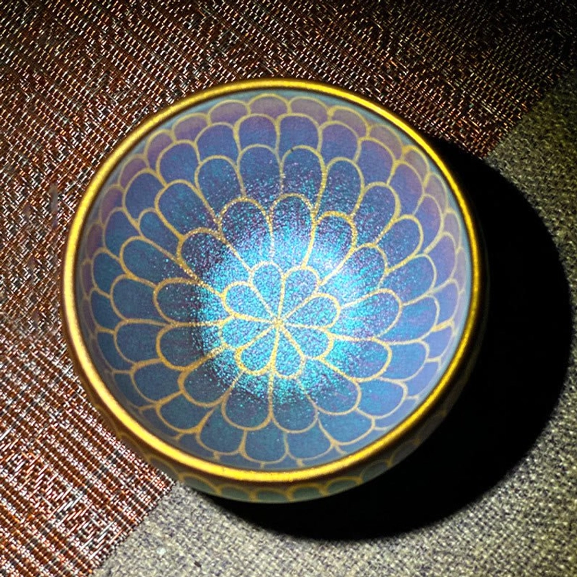 Artisan Jianzhan lotus petal pattern ceramic teacup with blue-purple gradient, gold rim, and scale-like gilded petal design overhead