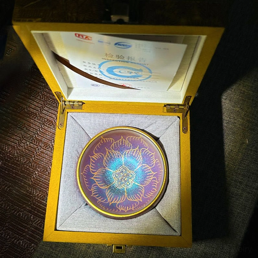 Handmade Jianzhan lotus ceramic tea cup in blue-purple gradient with gold details, presented in wooden gift box with authenticity certificate