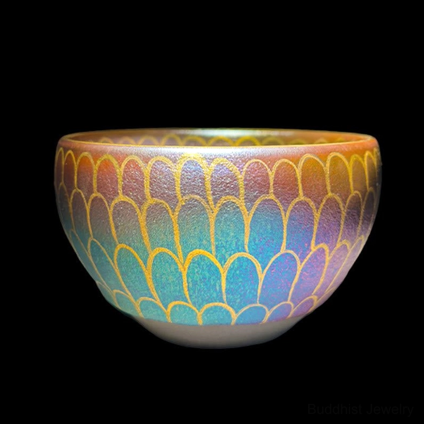 Jianzhan ceramic tea cup with gradient blue, purple and brown lotus petal patterns, scale-shaped gilded design on black background