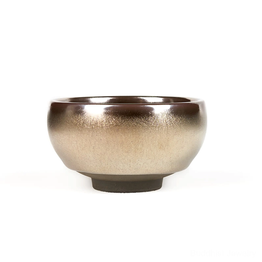 Jianzhan ceramic tea cup with silver-bronze gradient glaze and minimalist rounded shape, front side view white background