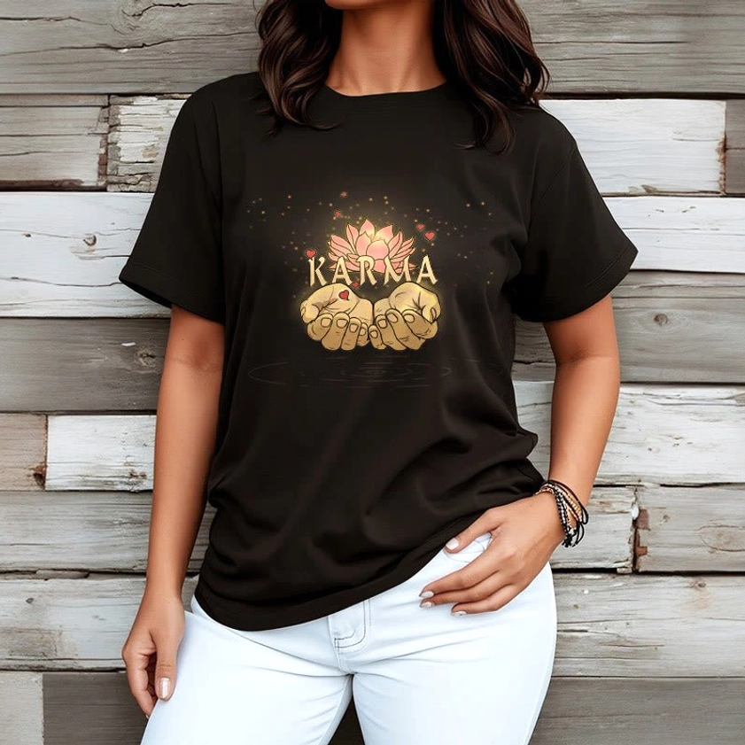 Black karma graphic tee worn by female model, front view demonstrating unisex fit on wooden plank background