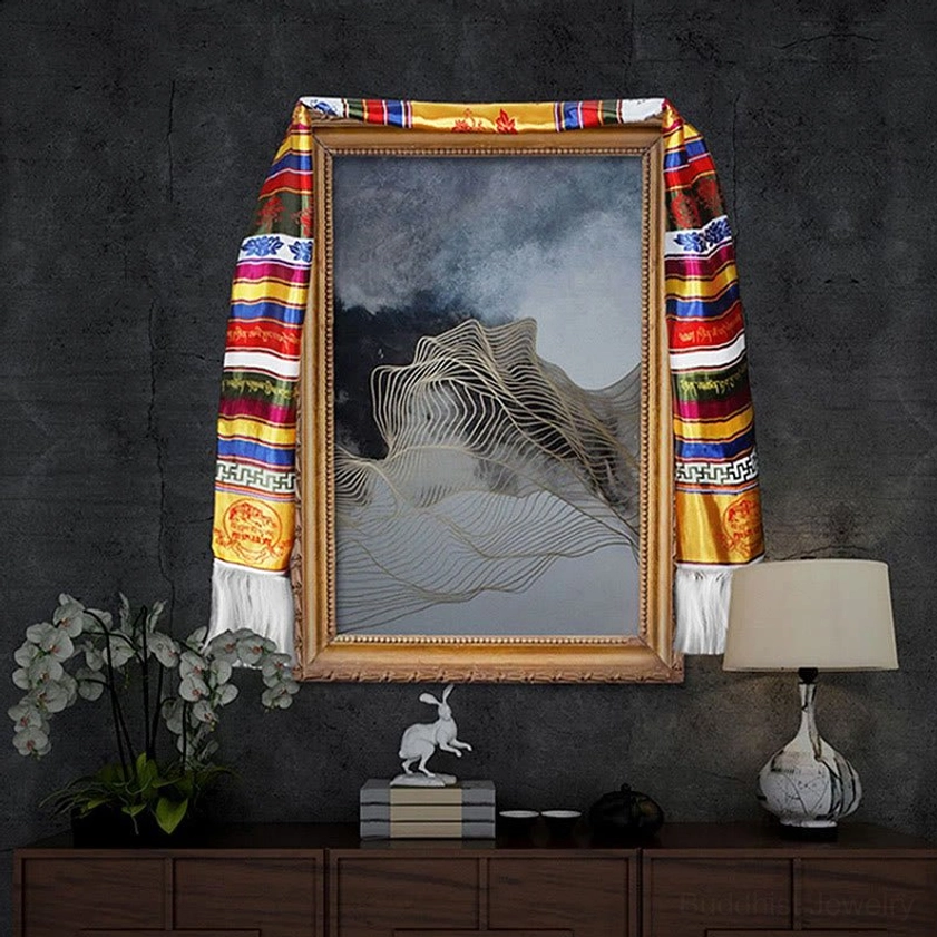 Multicolored Buddhist Khata blessing scarf hanging on wall frame showing full striped pattern with white tassels