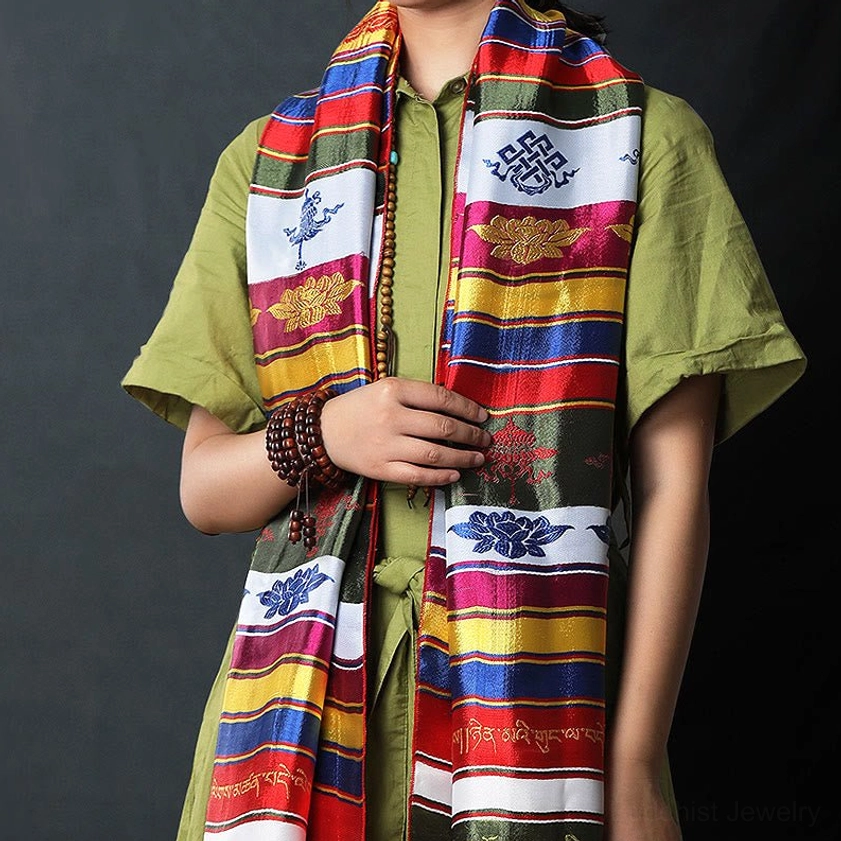 Buddhist Khata blessing scarf worn on model showing multicolored striped design with embroidered lotus and knot motifs