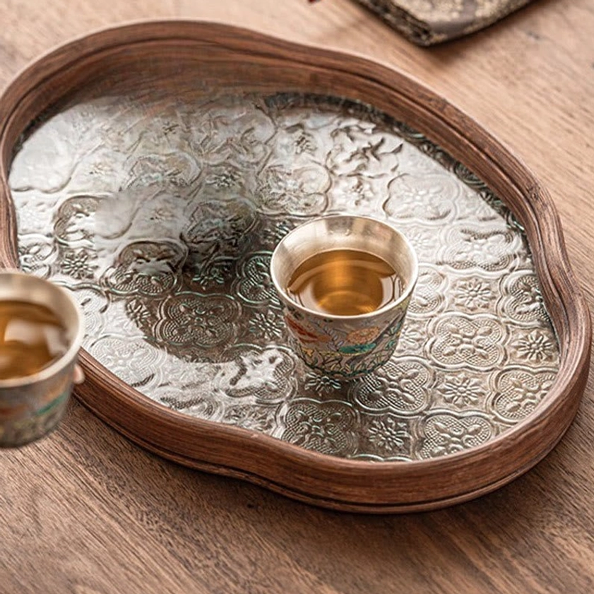 Ceramic tea cup with intricate fish and aquatic plant design, traditional kiln-fired technique