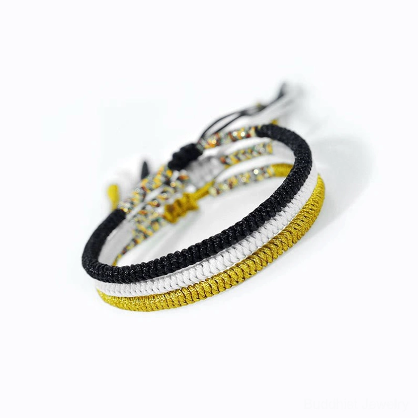 Buddhist amulet bracelet close-up showing braided knots and decorative beaded details woven design
