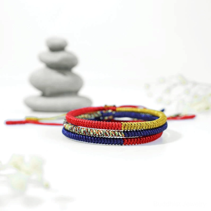 Handcrafted Buddhist protection bracelet displayed with meditation stones and spiritual decor