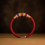 King Kong knot magnetic bracelet with red and black cord options on wooden surface - Buddhist protection jewelry