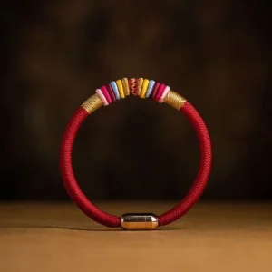 King Kong knot magnetic bracelet with red and black cord options on wooden surface - Buddhist protection jewelry