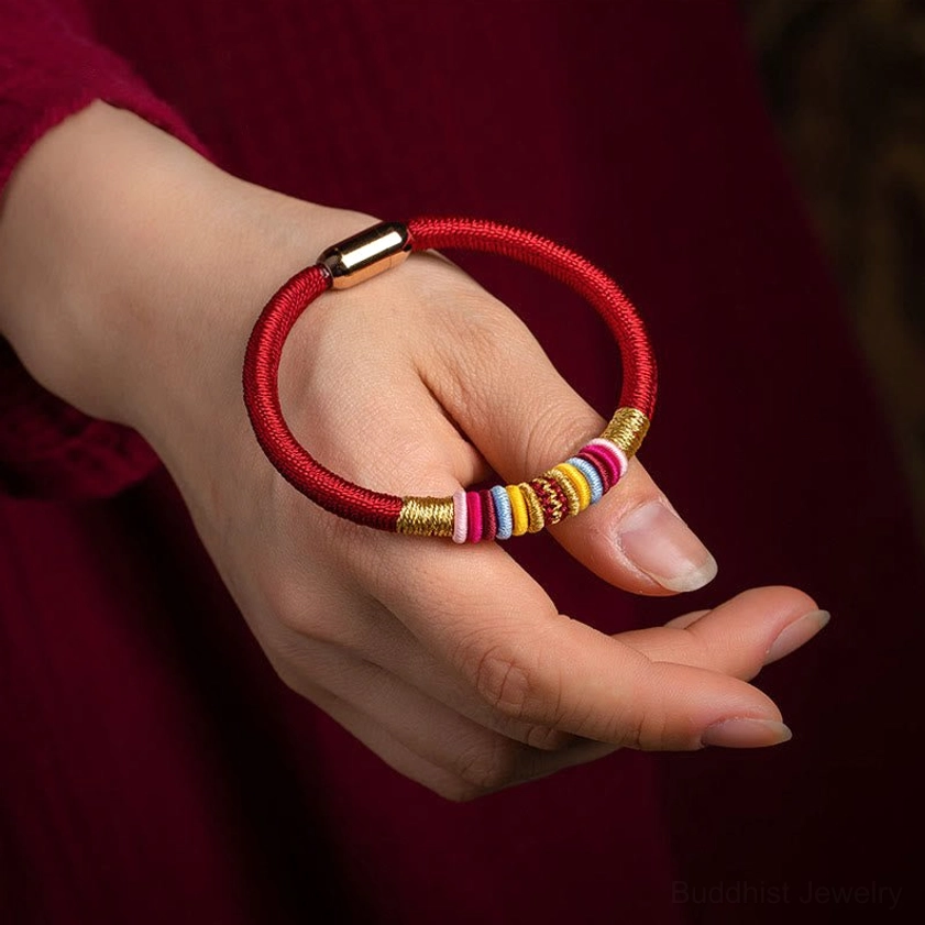 King kong knot protection bracelet worn on wrist showing fit and colorful decorative elements