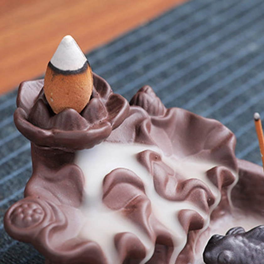 Koi fish themed purple clay incense burner showcasing flowing smoke backflow effect with goldfish figurines and artistic craftsmanship