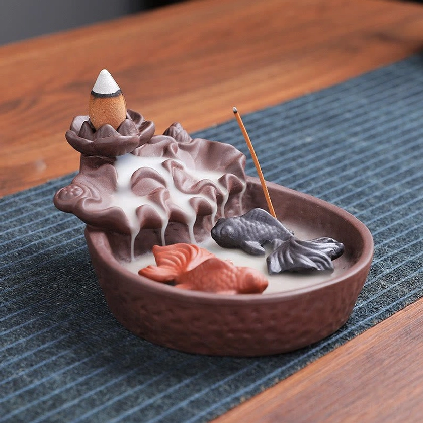 Handcrafted koi fish themed backflow incense burner with lotus-shaped holder, flowing smoke effect, golden fish figurines on wooden table