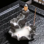 Koi fish backflow incense burner ceramic lotus design with flowing smoke on wooden tea tray