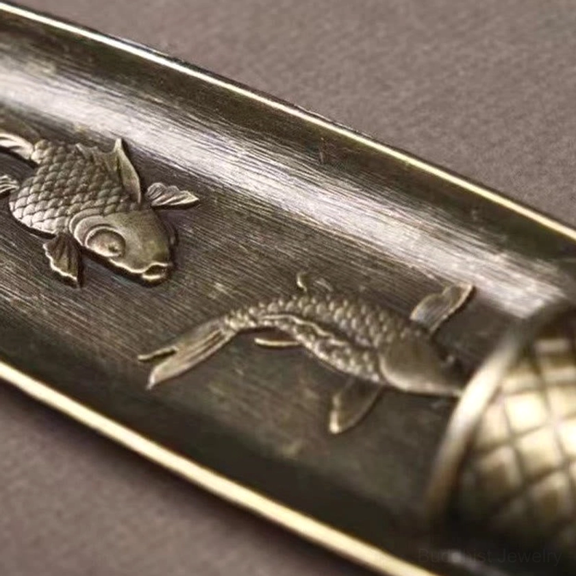 Buddhist koi fish boat incense burner front view showing intricate embossed fish and boat design in antique bronze