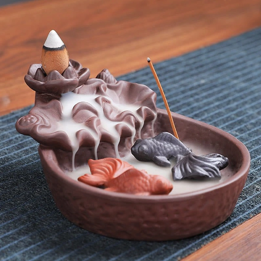 Koi fish purple clay backflow incense burner detail view showcasing handcrafted craftsmanship and flowing smoke pattern