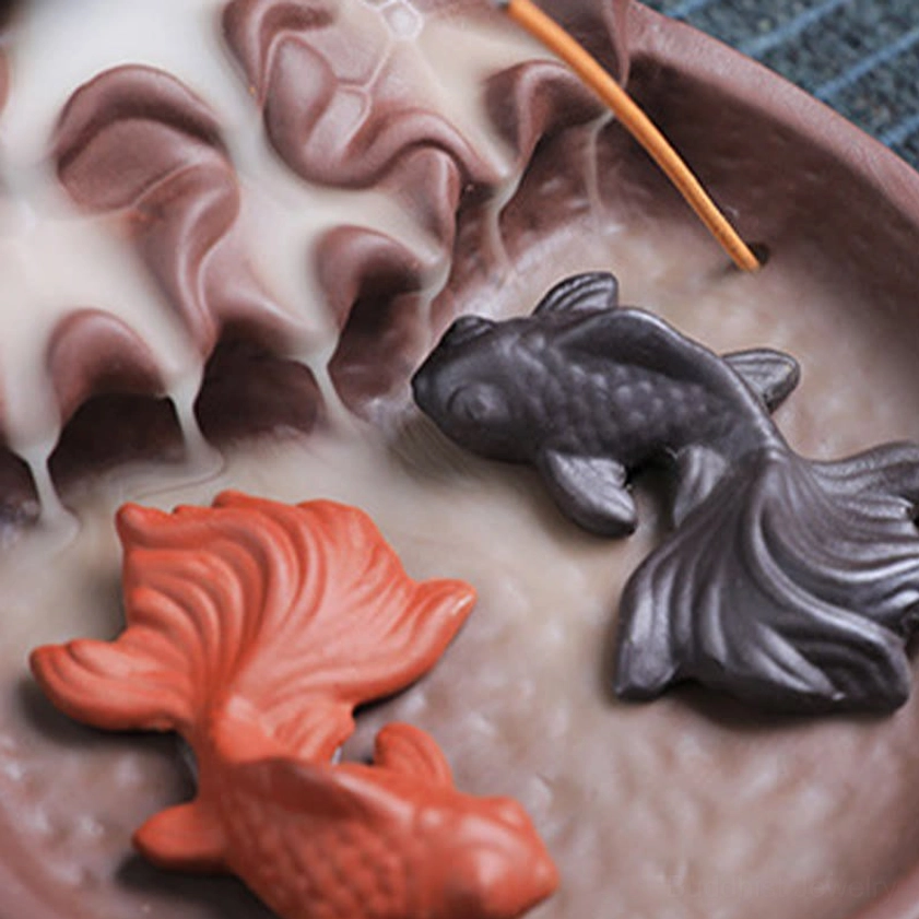 Koi fish incense burner right side view with brown ceramic finish, lotus-inspired design and compact structure on white background