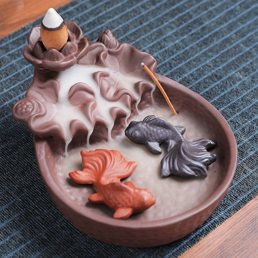 Koi fish ceramic incense burner oblique top view with brown ceramic finish, goldfish decorations, incense stick slot and visible smoke