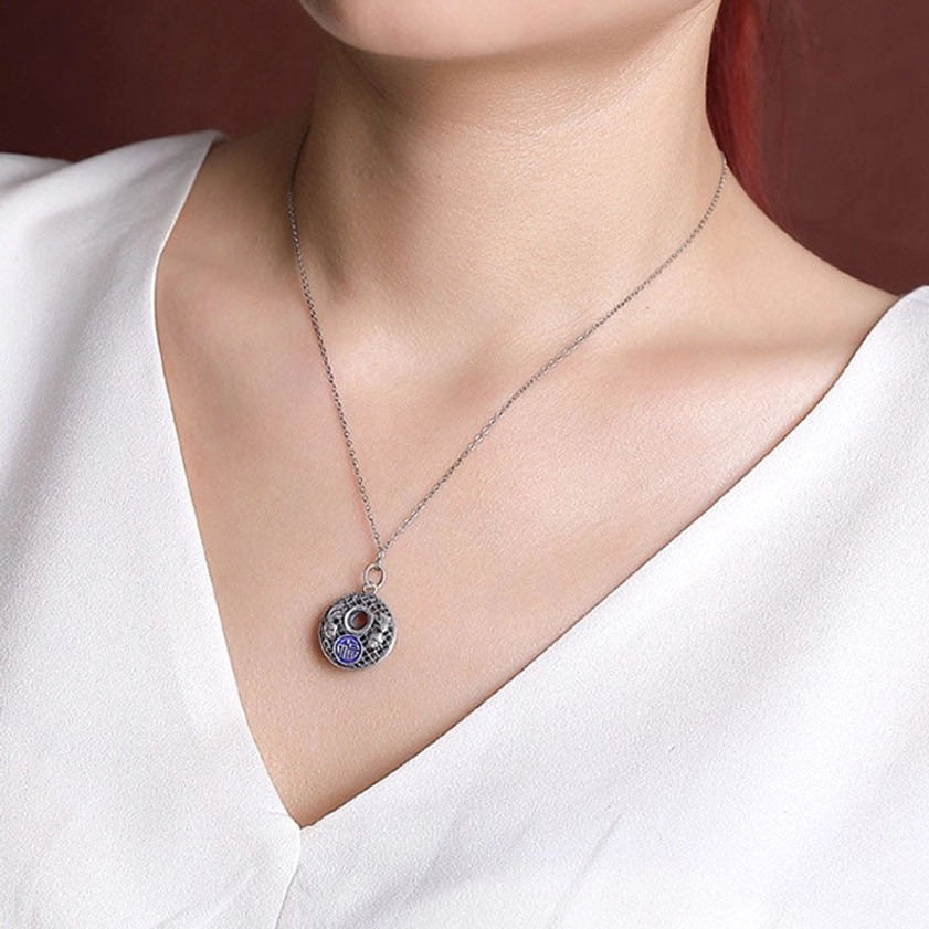 Silver koi fish fu pendant necklace worn at collarbone in casual daily outfit studio portrait