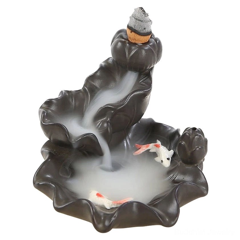Front three-quarter view ceramic koi fish incense burner with ruffled lotus tray pink-tailed white koi and flowing incense smoke