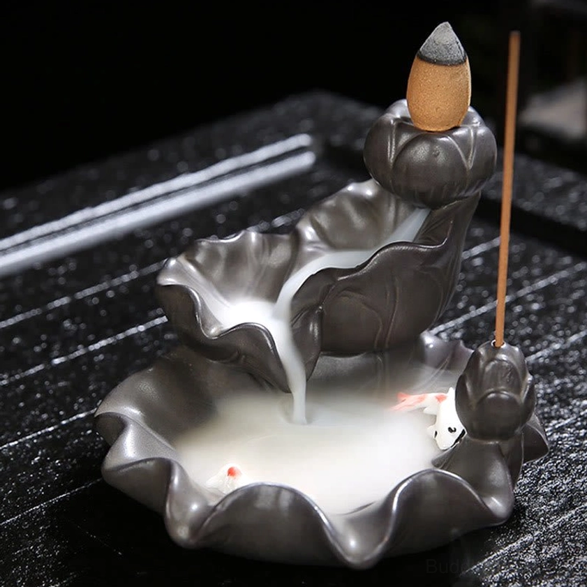 Side three-quarter view of ceramic koi fish incense burner with pink-tailed white koi and downward flowing smoke