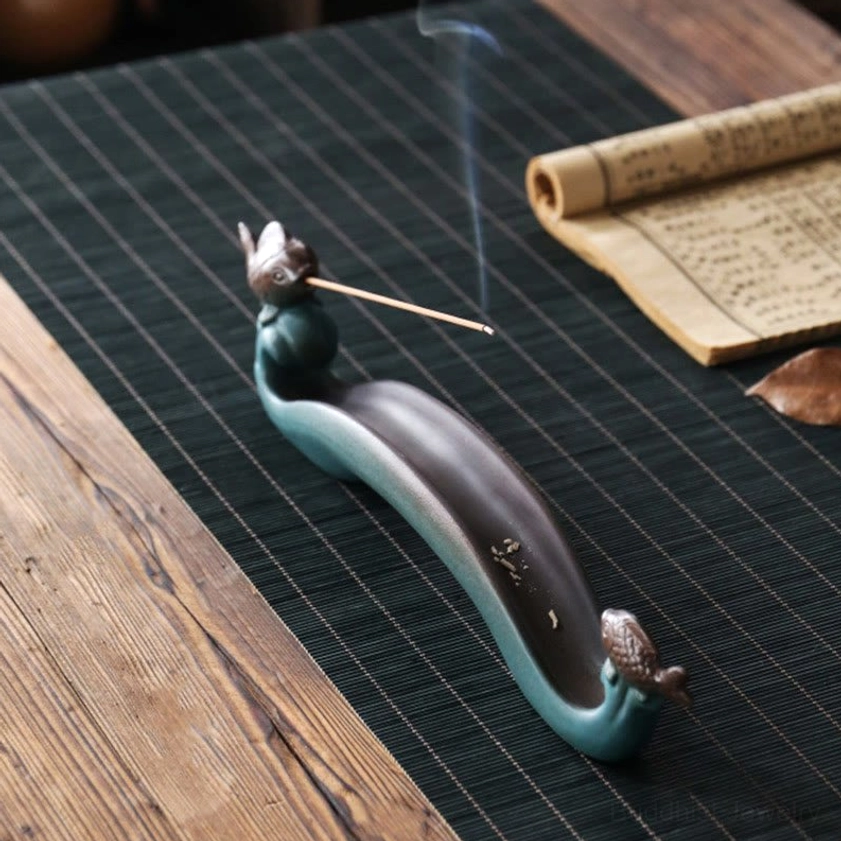 Double Koi Fish incense rack in profile showing slotted tray with burning incense