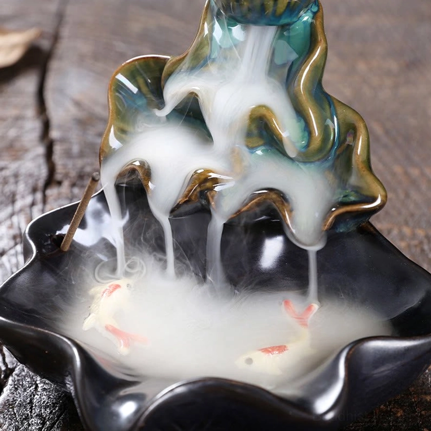 Koi fish patterns in tray with detailed glazed layers and flowing smoke