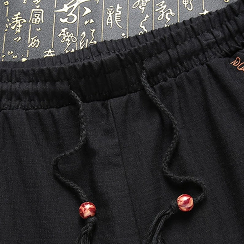 Tang suit pants waistband with elastic band and decorative red bead drawstring detail