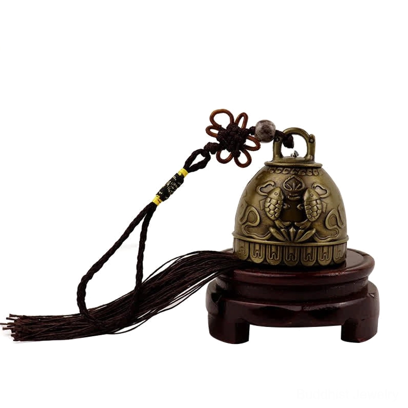Koi fish embossed wind chime bell with tassel pendant displayed on wooden stand showing craftsmanship