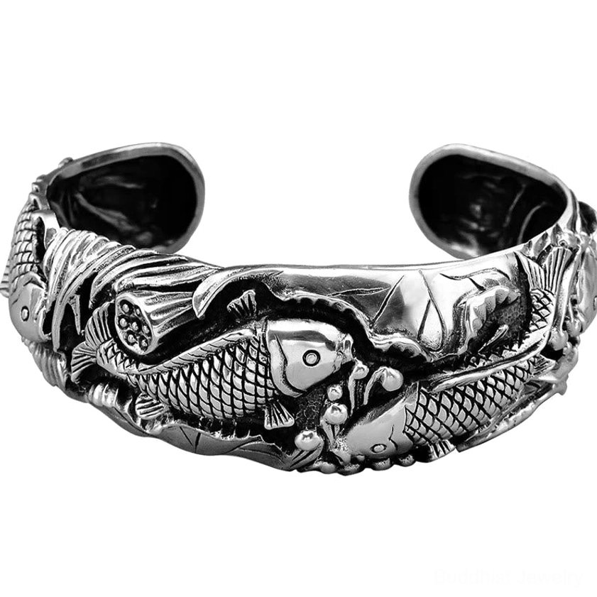 Flat lay overhead view of koi lotus wealth bracelet showing full carved design on white background