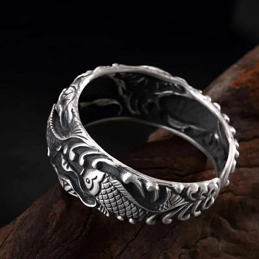 Textured koi fish lotus bracelet with engraved wave motifs and polished silver edges