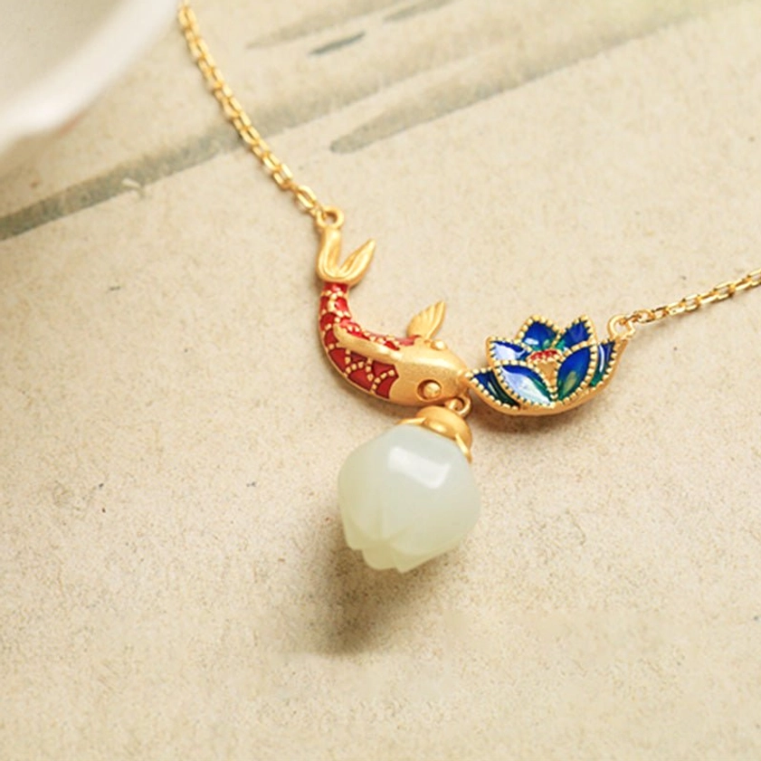 Complete white jade koi fish lotus Buddhist necklace laid flat showing full pendant set with smooth jade drop and gold hardware