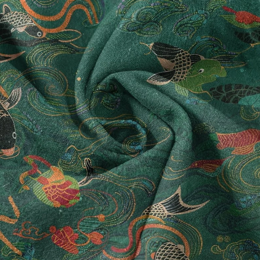 Close-up of fabric texture showing koi fish and lotus wave pattern on soft cotton material