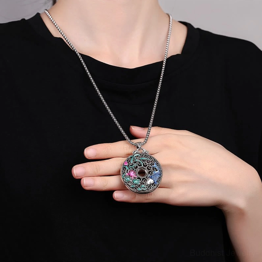 Koi lotus peace buckle Buddhist necklace worn on model - casual everyday wear with silver chain showing compact pendant size on black top