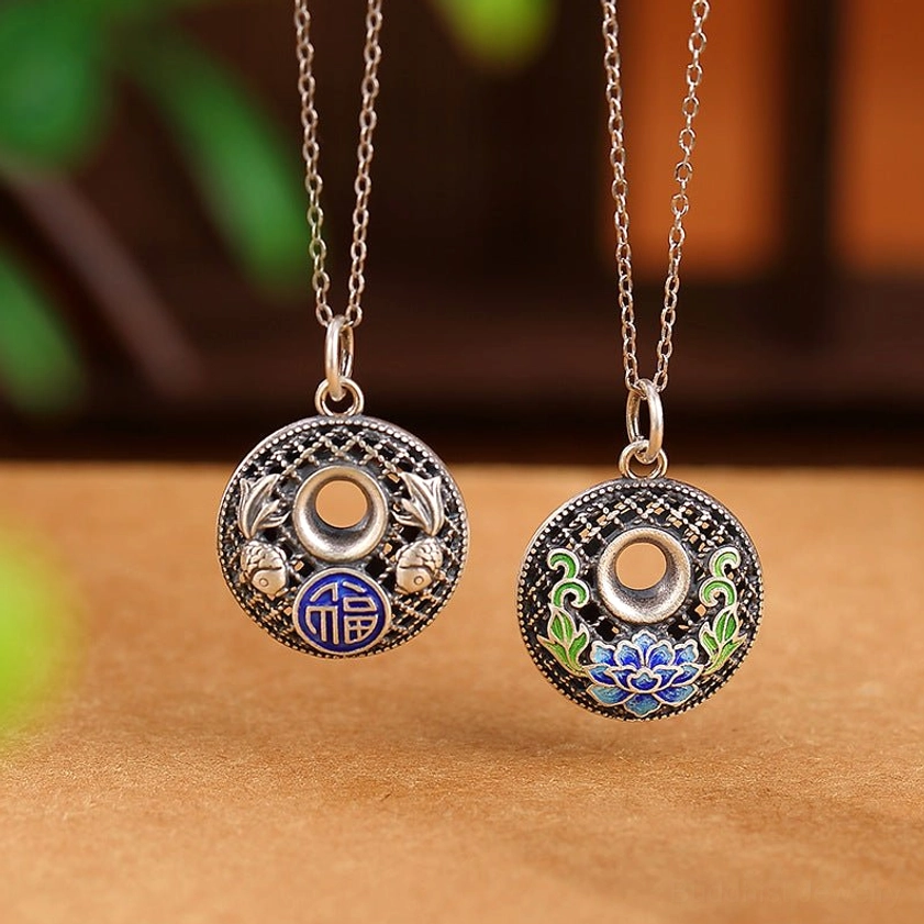 Two styles of 999 sterling silver koi fish fu character lotus peace buckle pendants side by side displaying filigree hollow design